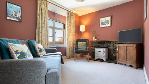 The sitting room at Tanner Brow, with everhot electric stove in the fireplace, Cumbria